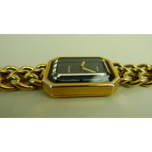 841 - A lady's gold plated Chanel watch, circa 1990, with black rectangular face with canted corners, gold... 