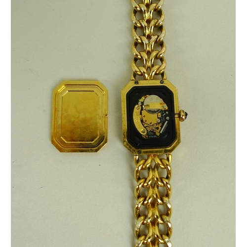 841 - A lady's gold plated Chanel watch, circa 1990, with black rectangular face with canted corners, gold... 