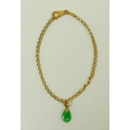 A 14ct gold and jade bracelet, the tear drop jade suspended on a link chain stamped '585 Brev', ston... 