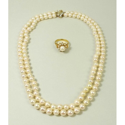 858 - A double strand of 128 pearls, set on a 15ct gold clasp with pave  set diamonds, 47cm long, together... 