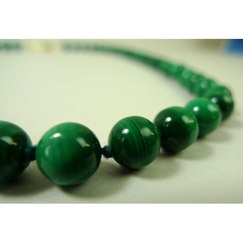 865 - A malachite bead necklace, 54cm long, bead diameter 8mm, with yellow metal clasp, together with an o... 