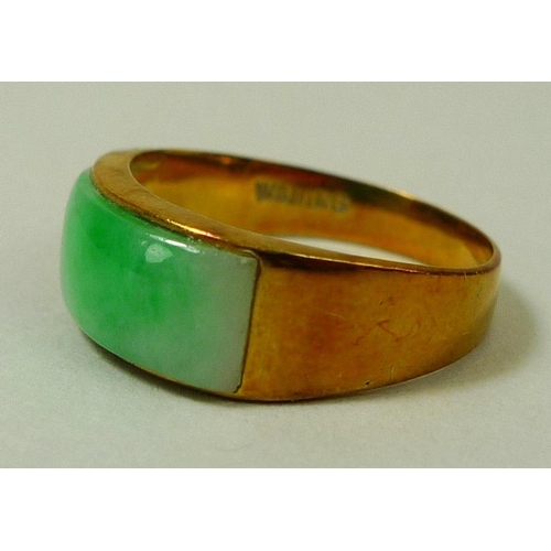 873 - An 18ct gold ring set with green apple jade, size M/N, 3.6g, together with a pair of apple jade unse... 