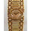 A Longines lady's 18K gold cased wristwatch, champagne enamel circular dial bearing gilt batons, ref... 