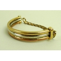 A 9ct tri-colour bangle, with chain link back, 56.5g total weight.