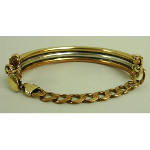 881 - A 9ct tri-colour bangle, with chain link back, 56.5g total weight.