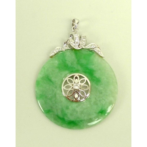 888 - A jade and diamond pendant, the carved jade disc set centrally with floral design and brilliant cut ... 