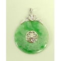 A jade and diamond pendant, the carved jade disc set centrally with floral design and brilliant cut ... 