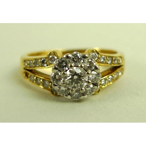 890 - A 22ct gold and diamond ring, the yellow gold band with split shoulders and white gold flowerhead se... 