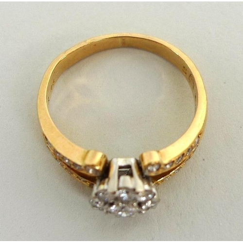 890 - A 22ct gold and diamond ring, the yellow gold band with split shoulders and white gold flowerhead se... 