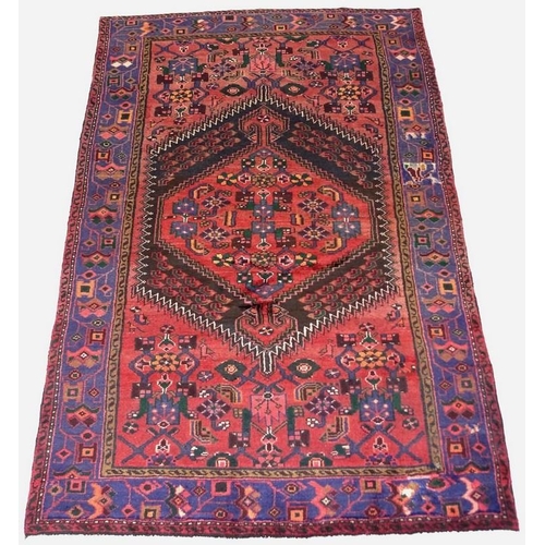 903 - A Hamadan rug with red ground, large central medallion with white sawtooth edging, stylised floral f... 