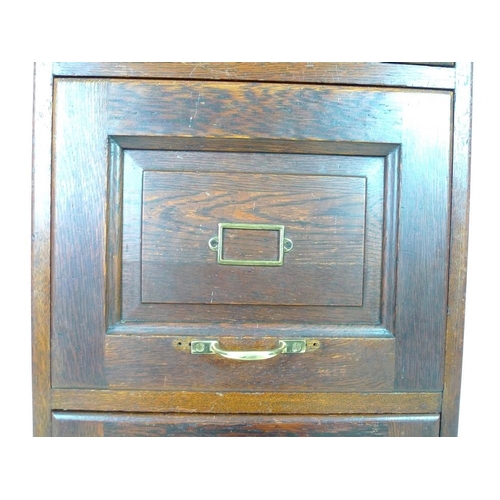 912 - An early 20th century oak five drawer filing cabinet, brass handles, the interiors fitted with remov... 