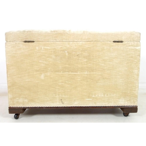 913 - An ottoman covered in cream velvet linen and raised on castors, 93 by 42 by 63cm high, together with... 