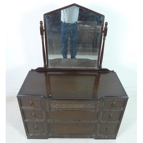 918 - A mahogany dressing chest, mid 20th century, with Gothic style pointed arch mirror on turned support... 