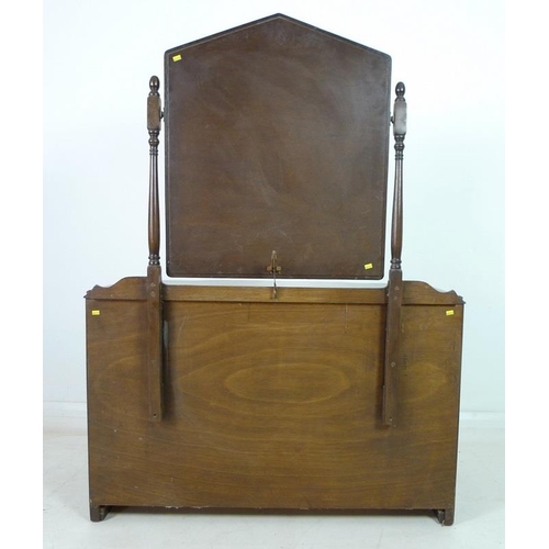 918 - A mahogany dressing chest, mid 20th century, with Gothic style pointed arch mirror on turned support... 