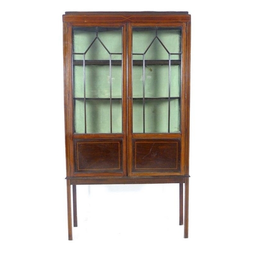 919A - An Edwardian mahogany display cabinet, with two astragal glazed doors and boxwood stringing, raised ... 