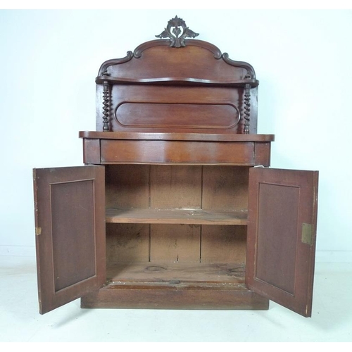 921 - A Victorian mahogany chiffonier, the gallery back with carved surmount and single shelf, below twin ... 