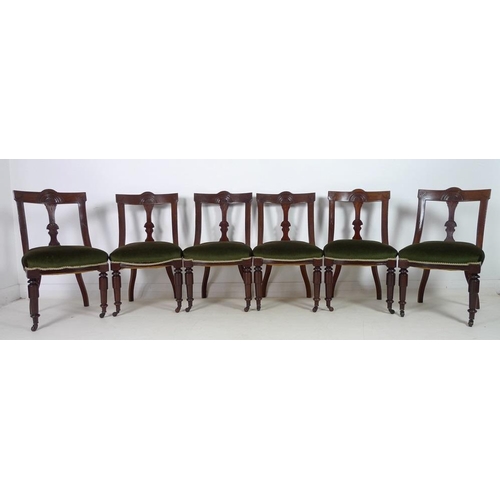 922 - A set of six Victorian Aesthetic mahogany dining chairs, bowed backs with carved decoration, upholst... 