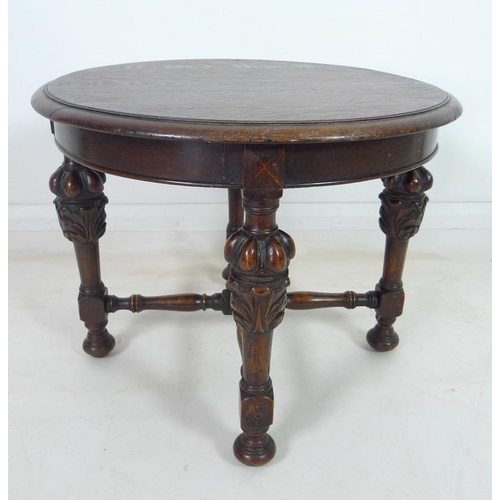 925 - An oak round coffee table with boldly carved legs and turned stretchers, 61 by 48cm high, together w... 