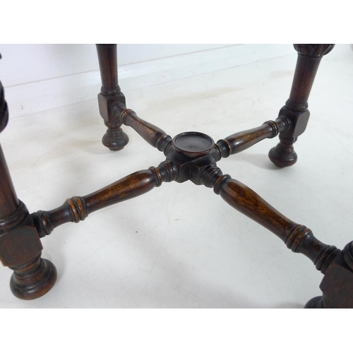 925 - An oak round coffee table with boldly carved legs and turned stretchers, 61 by 48cm high, together w... 