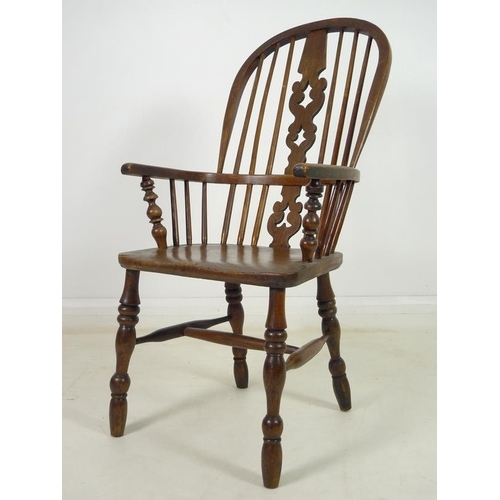 929 - A 19th century ash and elm high back Windsor armchair, with pierced and shaped splat, turned support... 