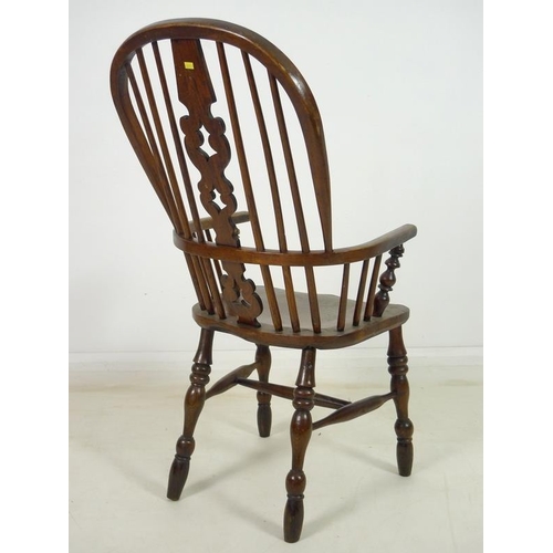 929 - A 19th century ash and elm high back Windsor armchair, with pierced and shaped splat, turned support... 