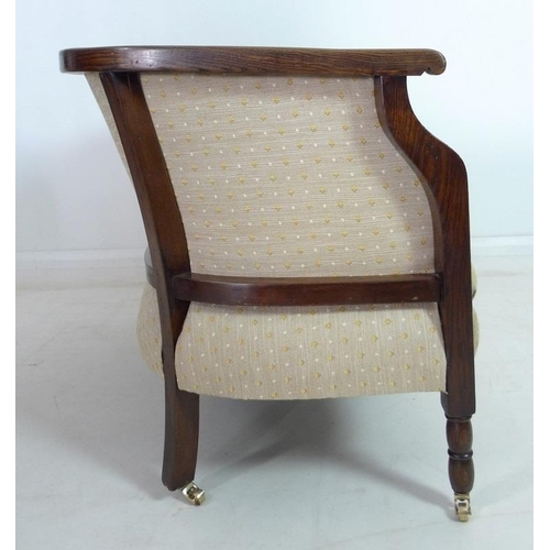 935 - An Edwardian mahogany part salon suite of tub armchair and small settee, upholstered in old gold col... 