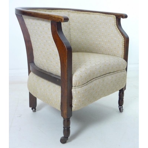 935 - An Edwardian mahogany part salon suite of tub armchair and small settee, upholstered in old gold col... 