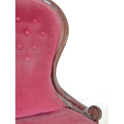 936 - A Victorian mahogany nursing chair, moulded frame, turned front legs and castors, upholstered in but... 