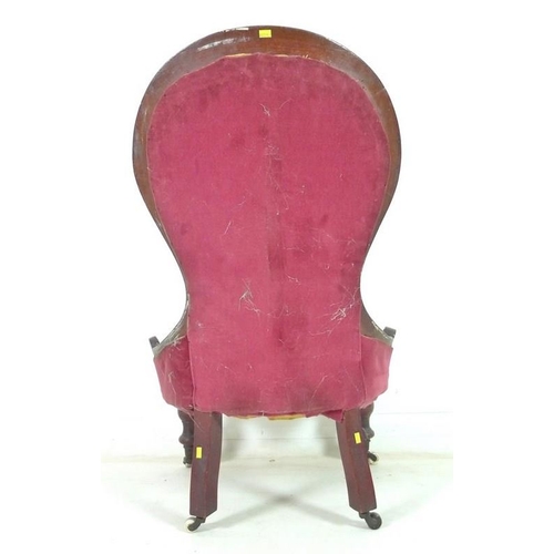 936 - A Victorian mahogany nursing chair, moulded frame, turned front legs and castors, upholstered in but... 