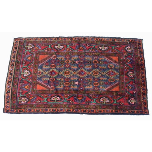 937 - An Arak rug with dark blue ground, stylised floral patterned field with small red corners, one wide ... 