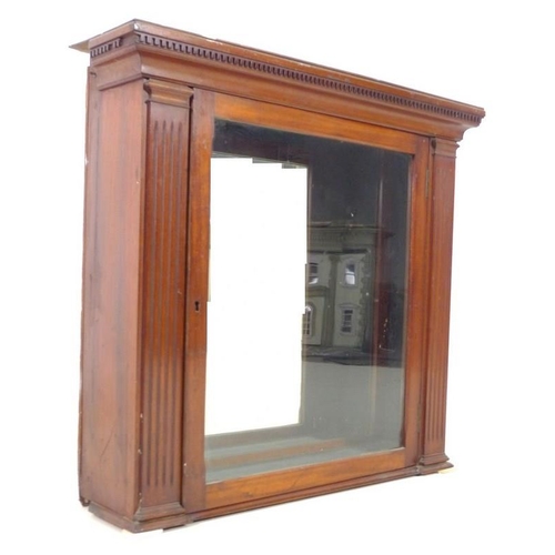 940 - A late Victorian mahogany wall hanging cupboard, with mirrored back and single glazed door, 77 by 21... 