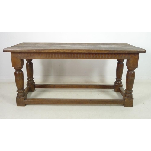 944 - A late 19th century oak refectory table, three plank surface over a chip carved frieze, supported on... 