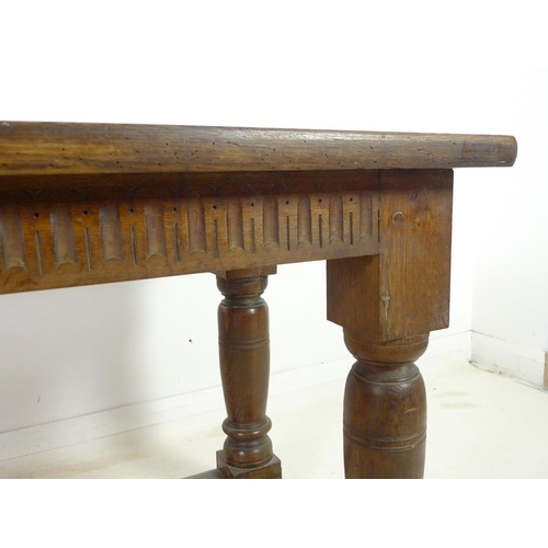 944 - A late 19th century oak refectory table, three plank surface over a chip carved frieze, supported on... 