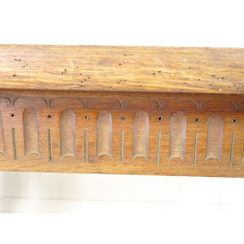 944 - A late 19th century oak refectory table, three plank surface over a chip carved frieze, supported on... 