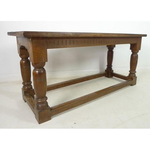 944 - A late 19th century oak refectory table, three plank surface over a chip carved frieze, supported on... 