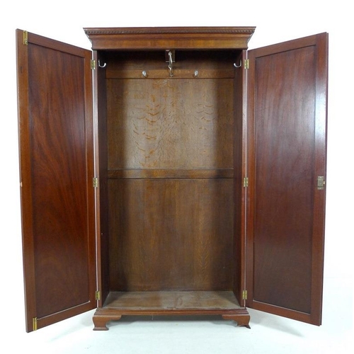 948 - A mid 20th century small mahogany and oak two door wardrobe, dentil moulded cornice, ogee bracket fe... 