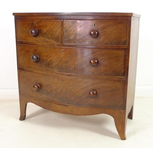 949 - A Regency mahogany bow fronted chest of two short over two long drawers, with turned handles and coc... 