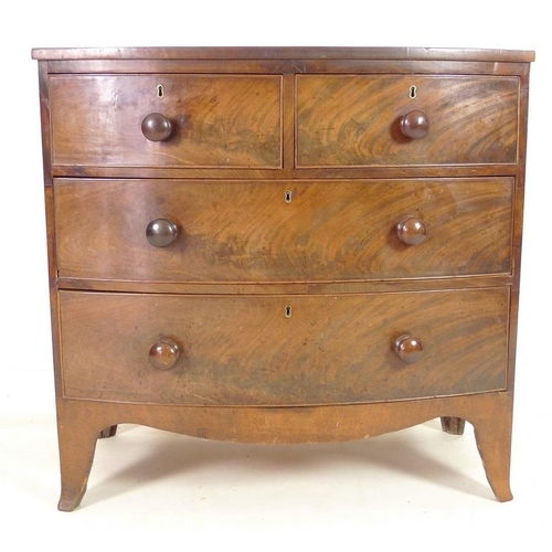 949 - A Regency mahogany bow fronted chest of two short over two long drawers, with turned handles and coc... 