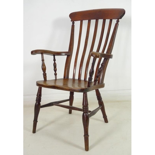 951 - A Victorian stained oak and beech high lathe back open armchair, with out-scrolled arms, raised on t... 