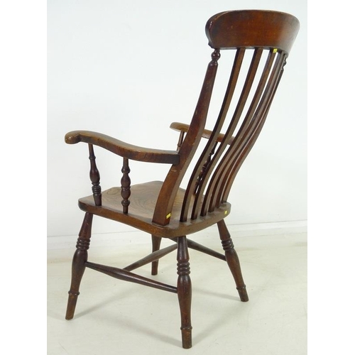 951 - A Victorian stained oak and beech high lathe back open armchair, with out-scrolled arms, raised on t... 