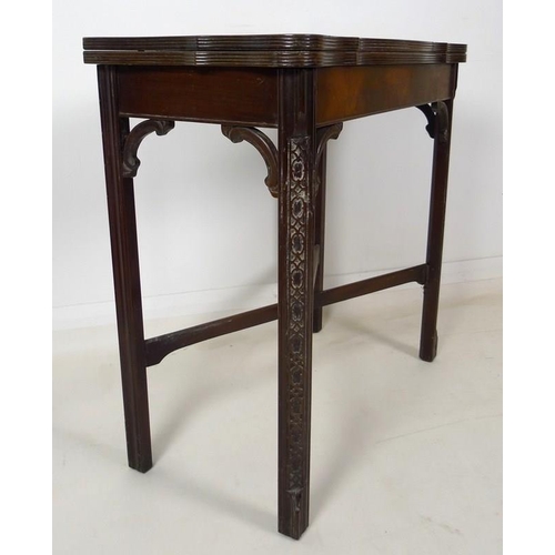 954 - A 19th century mahogany carved table, shaped fold over surface over a plain frieze, raised on chamfe... 