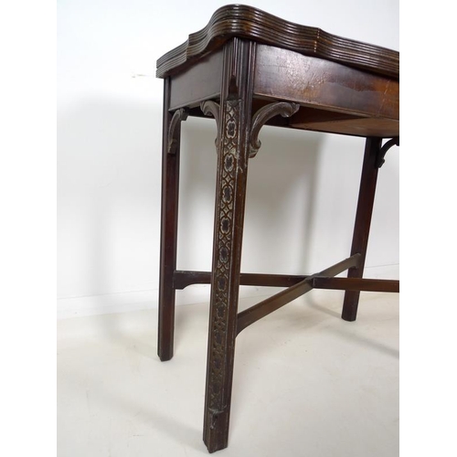 954 - A 19th century mahogany carved table, shaped fold over surface over a plain frieze, raised on chamfe... 