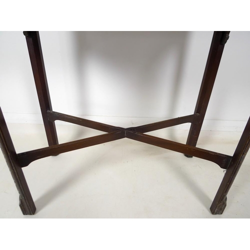 954 - A 19th century mahogany carved table, shaped fold over surface over a plain frieze, raised on chamfe... 