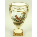 A porcelain urn, circa 1780, possibly Spode, with twin moulded handles, hand painted reserve of a ja... 