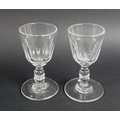 A pair of Georgian dram glasses, circa 1830, each with double knopped stems and slice cut lower bowl... 