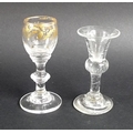An unusual Georgian liqueur glass, the bowl gilded with foliage, circa 1830, 9cm high, together with... 