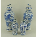 A pair of Chinese porcelain baluster vases and covers, Qing Dynasty, 19th century, decorated in unde... 