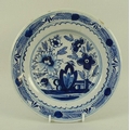An 18th century Delft blue and white dish, decorated with flowers, with leaf border, 23 by 3.5cm.