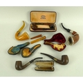 A group of 19th and 20th century pipes, including a meerschaum pipe carved as a an adult bulldog wit... 
