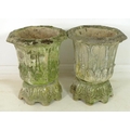 A pair of reconstituted stone garden octagonal urns, on matching eight footed pedestals, cast with s... 